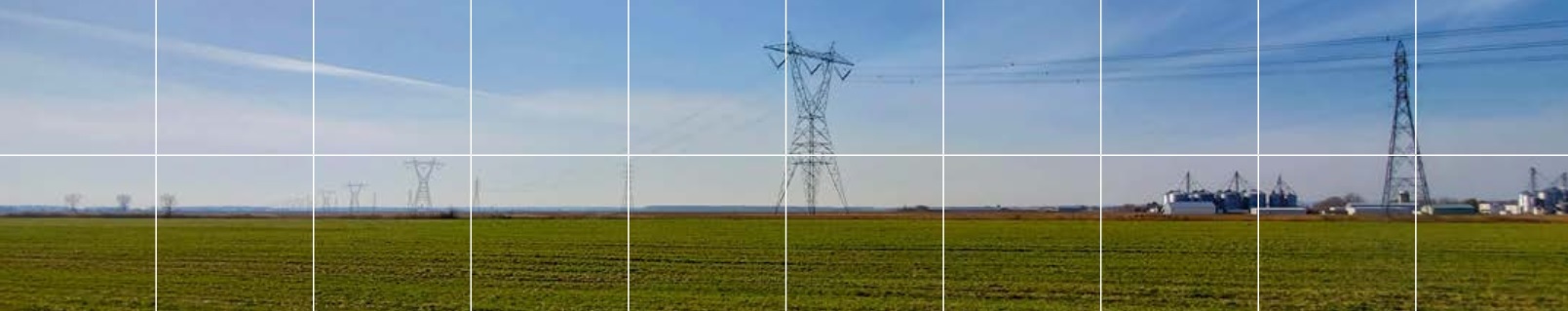 Farmland after plowing with electric pylon