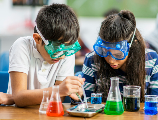 Two Indigenous children doing a science experiment