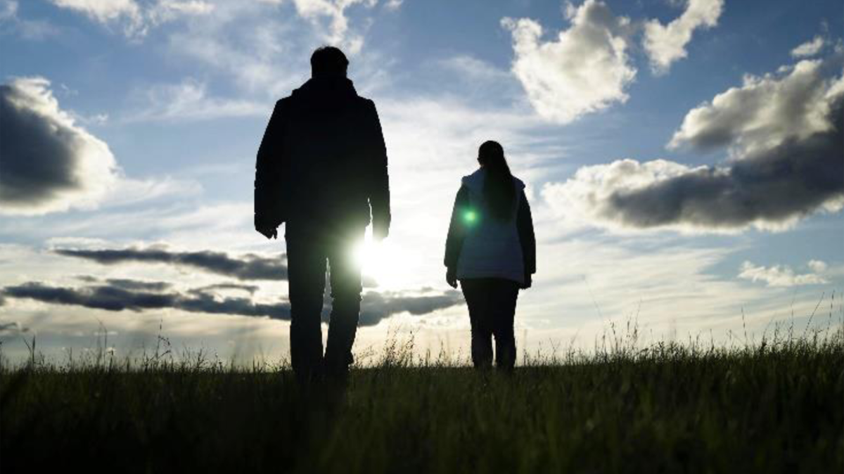 Figure 2 – Man and woman walking towards the sunset.