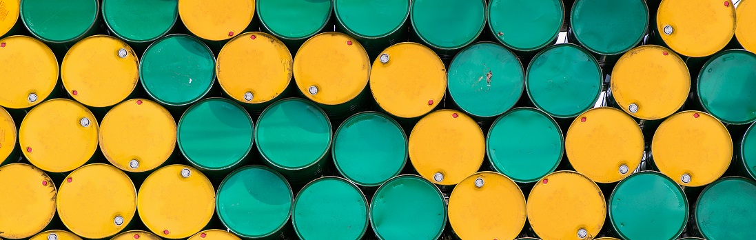 stacked yellow and green oil barrels