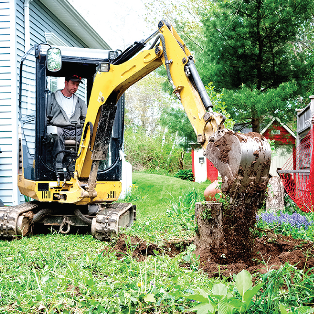 Trencher digging in residential area